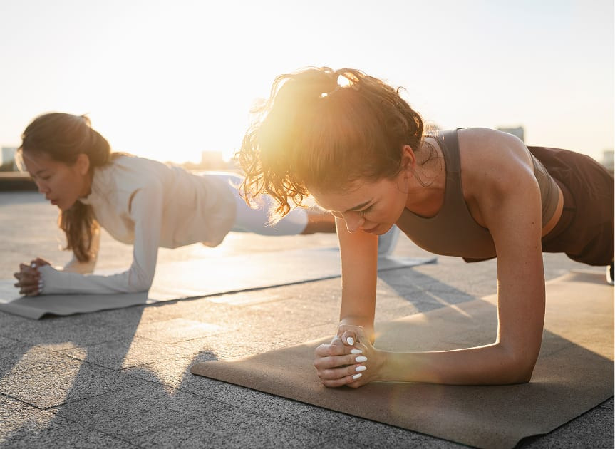 Woman holding a plank during an outdoor training session